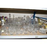 A COLLECTION OF MOSTLY CUT GLASS GLASSWARE, to include decanters, vases, bowls, water glasses,