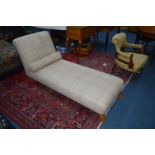 A MODERN CREAM TARTAN CHAISE LONGUE on brass casters, width 183cm