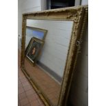 A LARGE LATE 20TH CENTURY FOLIATE GILT PLASTER BEVELLED EDGE WALL MIRROR, 200cm x 170cm (sd to