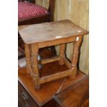 WILF SQUIRRELMAN HUTCHINSON, a rectangular oak stool, slightly arched top on a jointed base with