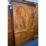 A GEORGIAN FLAME MAHOGANY DOUBLE DOOR LINEN PRESS, the oval panelled doors revealing five linen