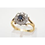 A SAPPHIRE AND DIAMOND CLUSTER RING, designed as a central circular blue sapphire within a brilliant