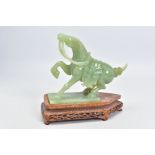 A CARVED GREEN BOWENITE HORSE ORNAMENT, together with a carved wooden plinth, horse measuring