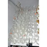 A SUITE OF UNMARKED CUT GLASS GLASSWARE to include claret jug, water glasses, sherry glasses, wine