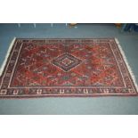 AN EARLY 20TH CENTURY AFSHAR WOOLLEN RED AND BLUE GROUND RUG, 208cm x 130cm together with a russet