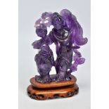 AN AMETHYST CARVING OF TWO ORIENTAL FIGURES, measuring approximately 120mm in height x 110mm in
