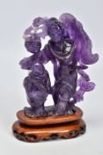 AN AMETHYST CARVING OF TWO ORIENTAL FIGURES, measuring approximately 120mm in height x 110mm in