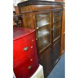 A MODERN OAK BOOKCASE with two glazed doors over two cupboard doors, width 117cm x height 183cm x