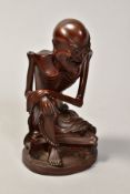 A JAPANESE HARDWOOD LAUGHING SEATED SKELETON, with part paper label to base, height 14cm