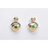 A PAIR OF EMERALD AND DIAMOND SET EARRINGS, each set with a central circular cut emerald within bi-