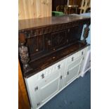 A HALF PAINTED OAK COURT CUPBOARD with stained carved top section and cream painted bottom