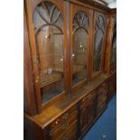 A LATE 19TH/EARLY 20TH CENTURY WALNUT TRIPLE DOOR BOOKCASE, with adjustable shelving above a base