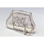 A GEORGE V SILVER PURSE, repousse decorated with roses and ribbons to both sides, on a chain with