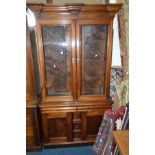 A VICTORIAN FLAME MAHOGANY GLAZED DOUBLE DOOR BOOKCASE, with glass adjustable shelves, two drawers