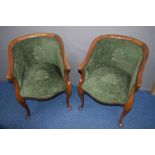 A PAIR OF LATE 19TH/EARLY 20TH CENTURY WALNUT ARMCHAIRS with swept arm rests covered with green