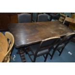 AN OAK REFECTORY TABLE WITH ACORN LEGS, length 165cm and four chairs with studded leatherette