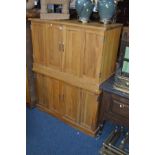 TWO MATCHING GOLDEN OAK DOUBLE BI FOLD DOOR CABINETS, the interior with two sections with a