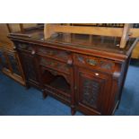 AN EDWARDIAN WALNUT SIDEBOARD with a central hutch below two drawers flanked by one cupboard and one