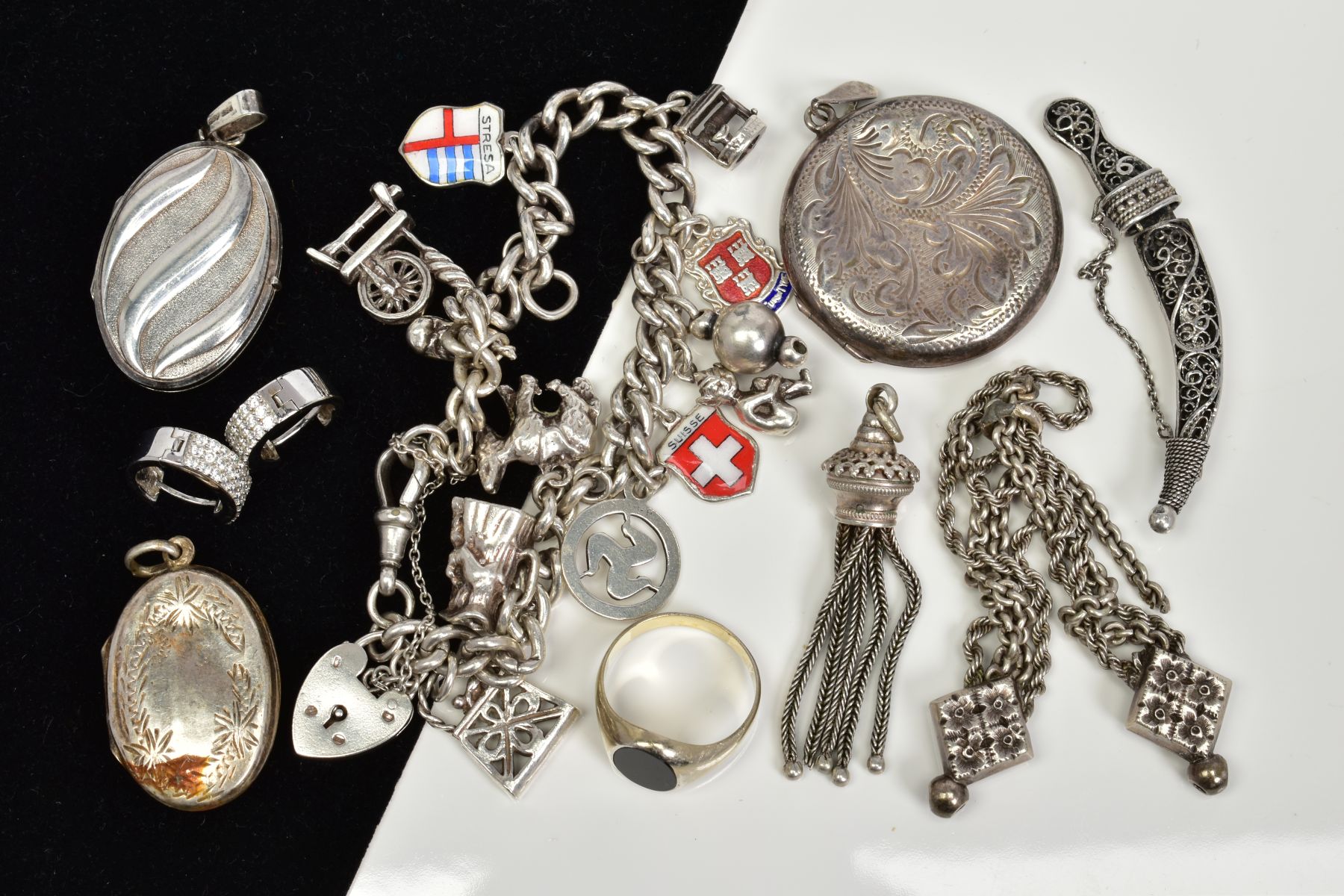 A SELECTION OF SILVER AND WHITE METAL JEWELLERY, to include a charm bracelet, three lockets, a