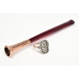 AN EARLY 20TH CENTURY CIGARETTE HOLDER AND MARCASITE RING, the tapered red plastic cigarette
