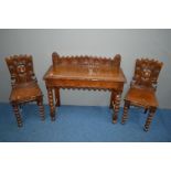 AN EARLY 20TH CENTURY CARVED OAK HALL TABLE decorated with foliate and roundel decoration, the table