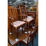 A MODERN MAHOGANY DINING SUITE to include a extending table, eight chairs, similar two door bookcase