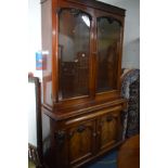 A VICTORIAN FLAME MAHOGANY GLAZED TWO DOOR BOOKCASE, with foliate and grape decoration, a single