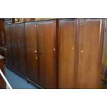 A STAG MINSTREL SIX PIECE BEDROOM SUITE comprising a triple and two sized double wardrobes, dressing
