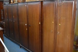 A STAG MINSTREL SIX PIECE BEDROOM SUITE comprising a triple and two sized double wardrobes, dressing
