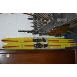 A PAIR OF YELLOW GROUND WATER SKI'S (sd)