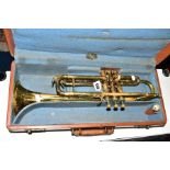 A CASED REGENT BRASS TRUMPET (finish is worn)