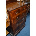 AN EDWARDIAN MAHOGANY AND BANDED TALL BOY, with a raised back, three drawers above double cupboard