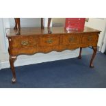 A REPRODUCTION WALNUT DRESSER BASE with four drawers, brass swan neck handles, pierced back plate,