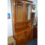 A MODERN OAK EFFECT TV STAND with one glass door and one drawer, width 130cm, a modern oak dresser