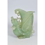 A CARVED BOWENITE VASE, carved to depict a phoenix with the curved vase section between the wings,