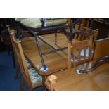 AN EARLY 20TH CENTURY ARTS AND CRAFTS GOLDEN OAK WIND OUT DINING TABLE, canted corners, with one