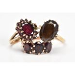 THREE GEM SET RINGS, the first set with an oval smoky quartz, the second an oval garnet within a