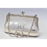 A GEORGE V SILVER PURSE, scrolled edges, engraved initials, on a chain with finger ring, brown