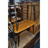 A PAIR OF MID CENTURY COFFEE TABLES with laminated walnut tops on circular tapered legs with brass