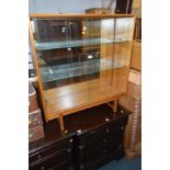 A MID CENTURY BOOKCASE with two sliding glass doors, width 92cm x height 101cm x depth 218cm