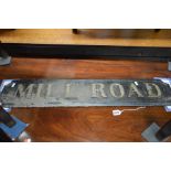 AN EARLY 20TH CENTURY BLACK GROUND CAST IRON ROAD SIGN reading Mill Road, width 89cm