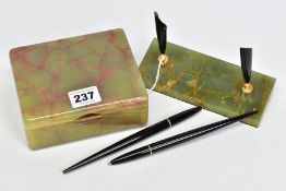 A GREEN ONYX DESK SET, comprised pen holder which houses two black ball point pens which are mounted