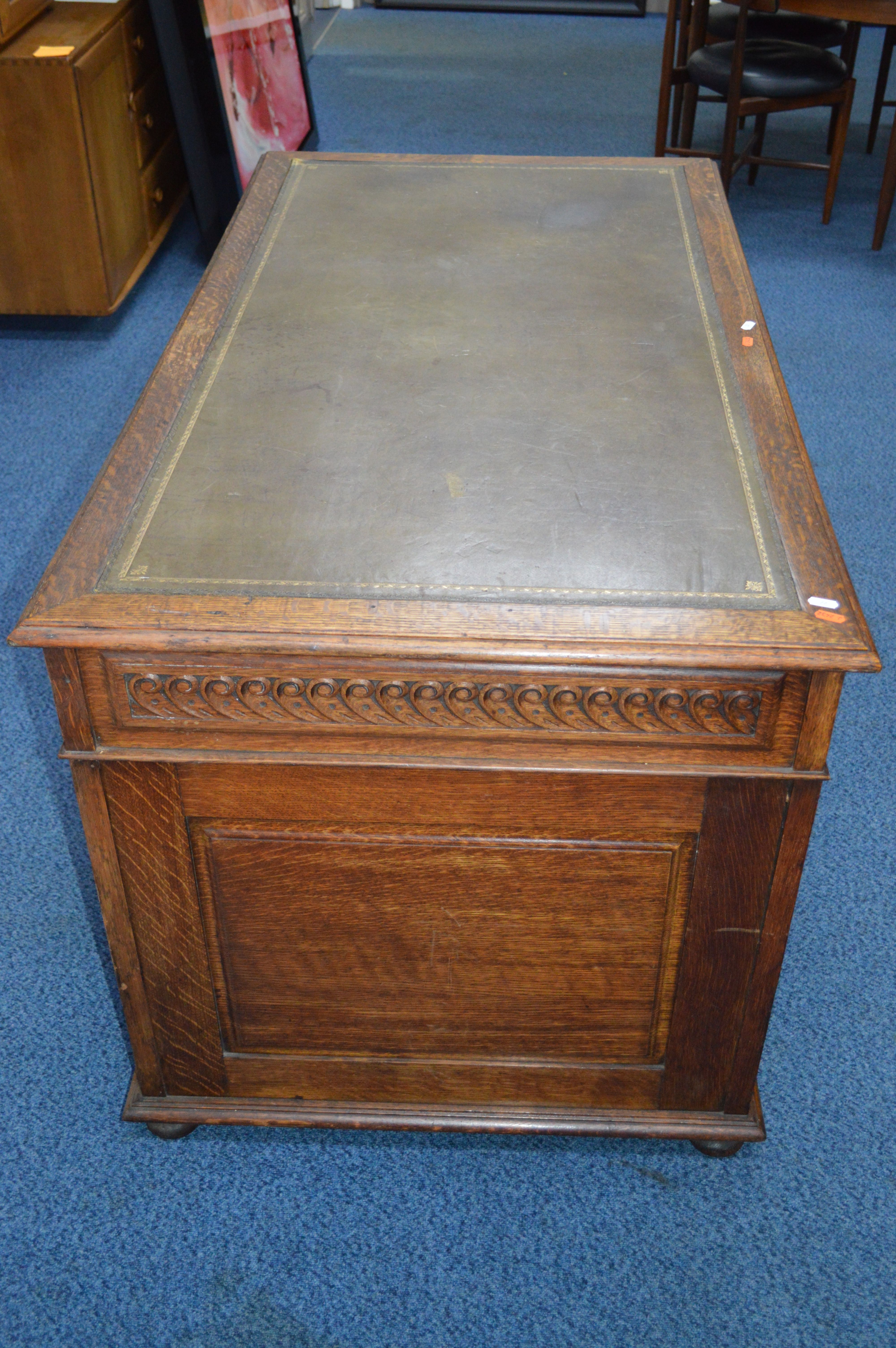 AN EARLY 20TH CENTURY CARVED OAK PEDESTAL DESK, dark green gilt tooled leather inlay top and nine - Image 2 of 3
