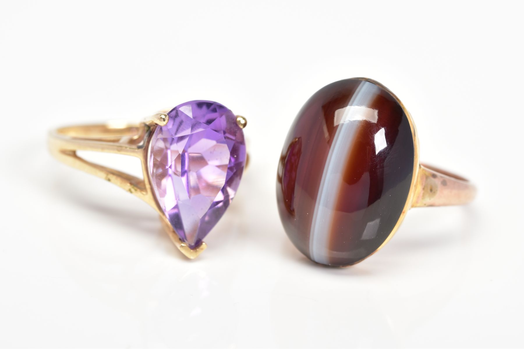 TWO GEM SET RINGS, the first set with an oval agate cabochon, stamped 9ct, ring size O, the second a