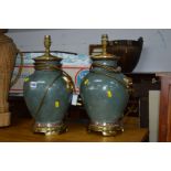 A PAIR OF GREEN GROUND CERAMIC AND BRASSED TABLE LAMPS