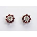 A PAIR OF 9CT GOLD GARNET AND DIAMOND CLUSTER EARRINGS, the stud earrings each designed as a central