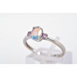 A 9CT WHITE GOLD CUBIC ZIRCONIA RING, designed as a central oval opalescent cubic zirconia flanked