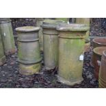 A PAIR OF CLAY CYLINDRICAL CHIMNEY POTS, height 65cm (s.d. to base of one pot), together with a