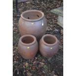 A LARGE GLAZED TERRACOTTA CYLINDRICAL PLANTER, rim diameter 42cm x height 60cm, together with two