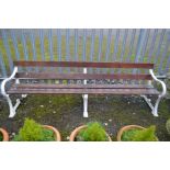 A VICTORIAN WHITE GROUND CAST IRON TRIPLE SUPPORT GARDEN BENCH, with five stained teak slats, marked